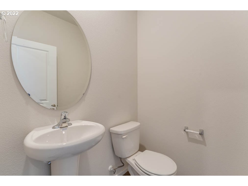 2684 26th Loop Springfield, OR 97477 - Photo 8 of 23 a bathroom with a toilet a sink and mirror