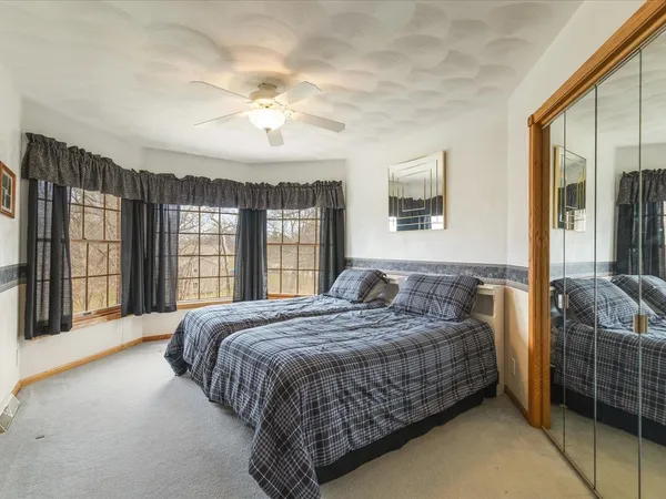 a bedroom with a large bed and a large window