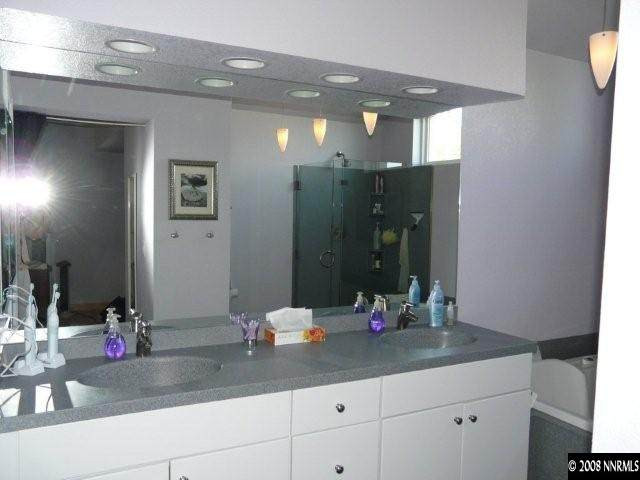 6245 Alpine Meadows Road Reno, NV 89519 - Photo 5 of 7 a bathroom with a sink and a mirror