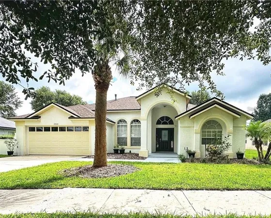 a front view of a house with a garden and yard
