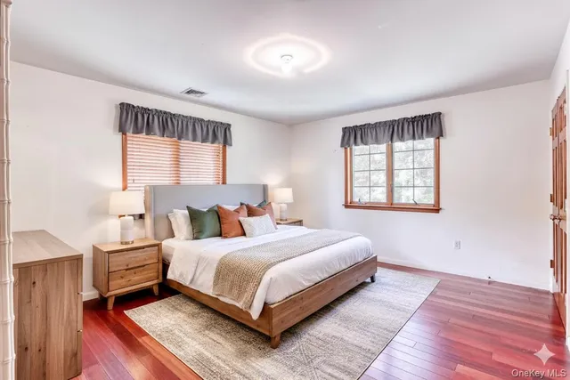 a bedroom with a bed lamp closet and window