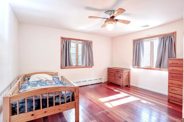 a bedroom with furniture and a window