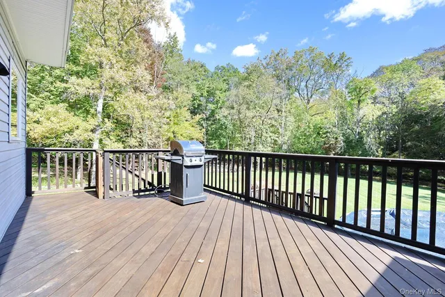 a balcony with wooden floor and trees