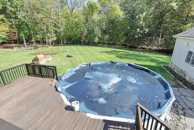 a view of a swimming pool with a yard