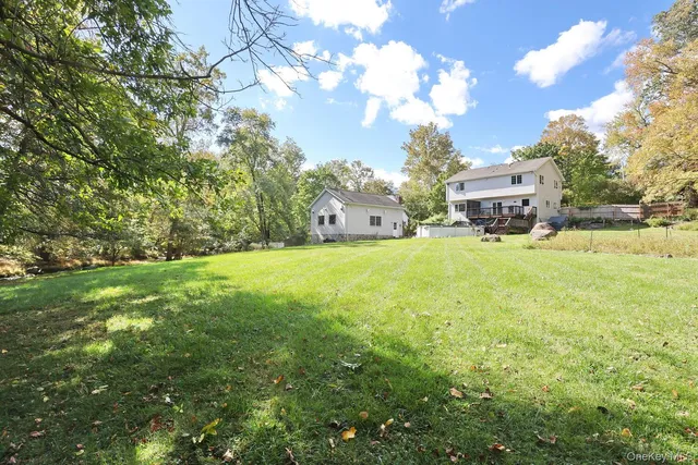 a view of a house with a yard and sitting area