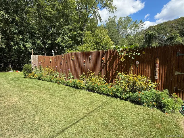an aerial view of a house with a yard and swimming pool