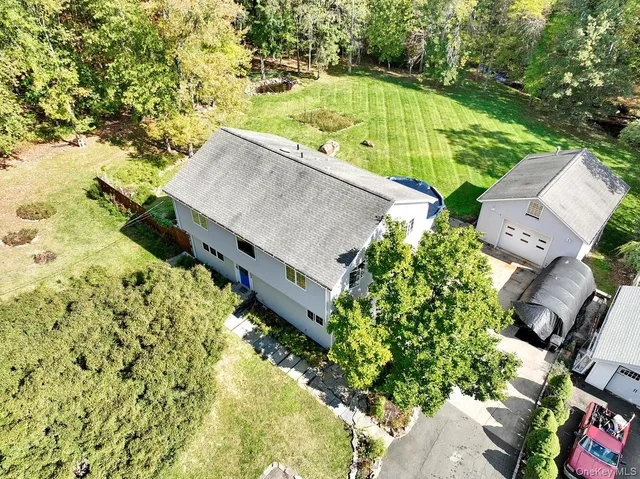 an aerial view of residential house with yard and swimming pool