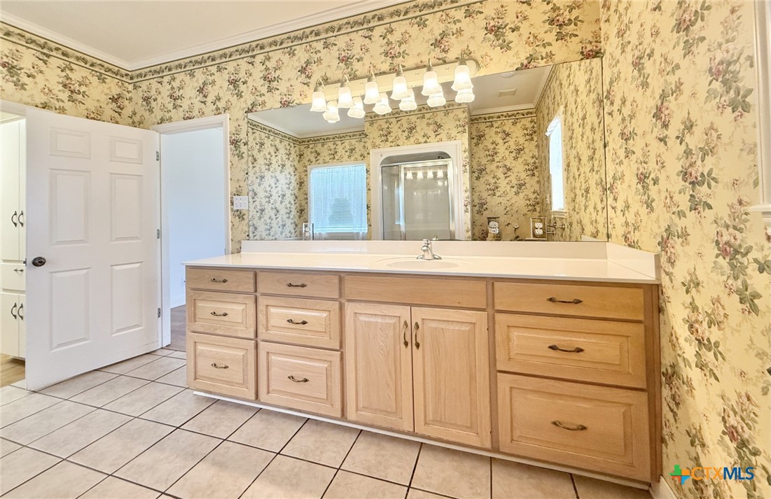 415 South Trinity Street Edna, TX 77957 - Photo 24 of 46 a bathroom with a sink mirror and