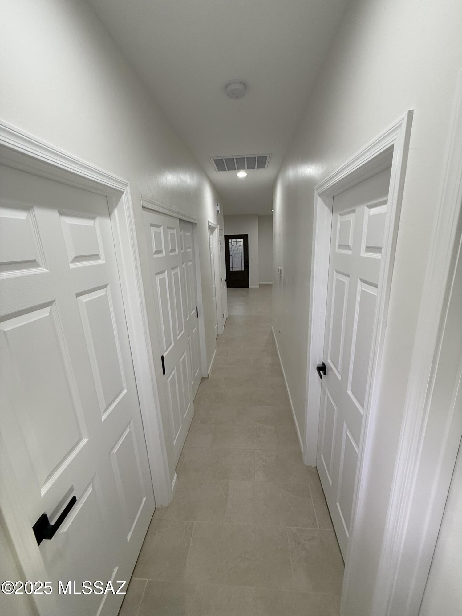 104 Escocia Court Rio Rico, AZ 85648 - Photo 7 of 10 a view of a hallway with wooden floor and staircase