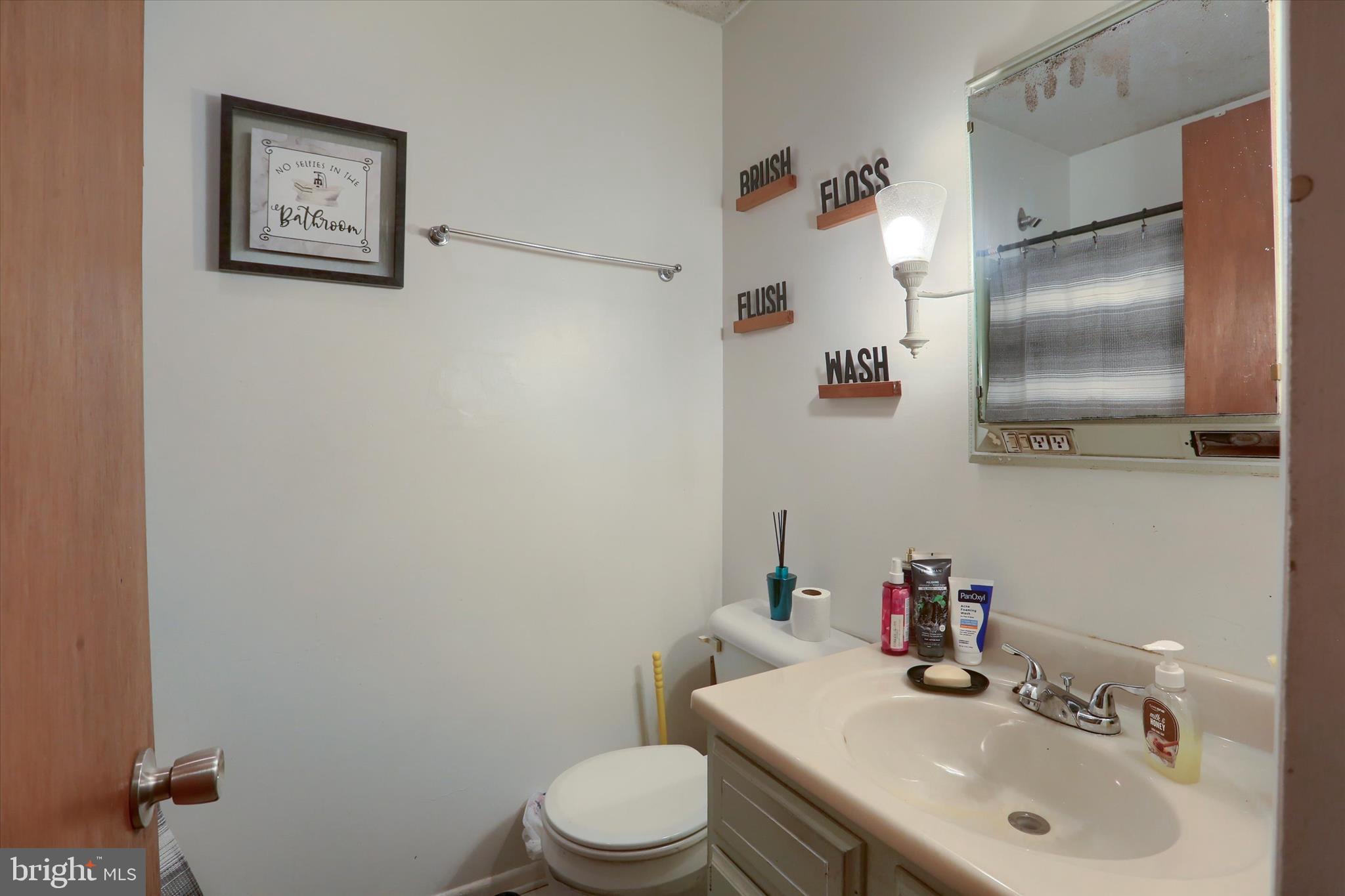 2337 Thornton Road Harrisburg, PA 17109 - Photo 12 of 34 a bathroom with a sink mirror and toilet