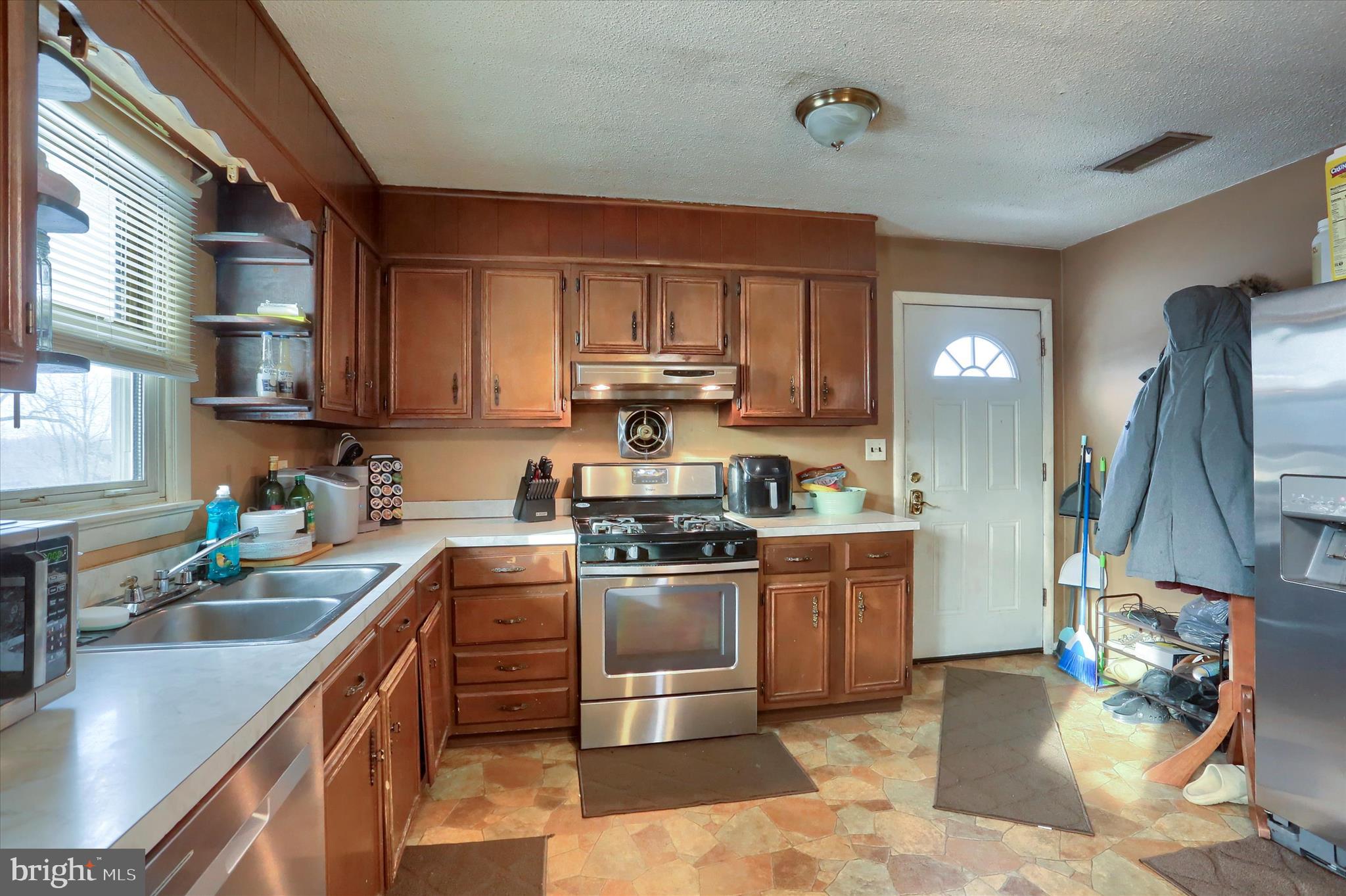 2337 Thornton Road Harrisburg, PA 17109 - Photo 10 of 34 a kitchen with stainless steel appliances granite countertop a sink stove and refrigerator