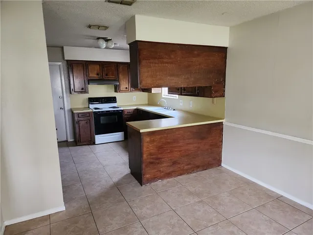 a kitchen with stainless steel appliances granite countertop a stove a refrigerator and a sink