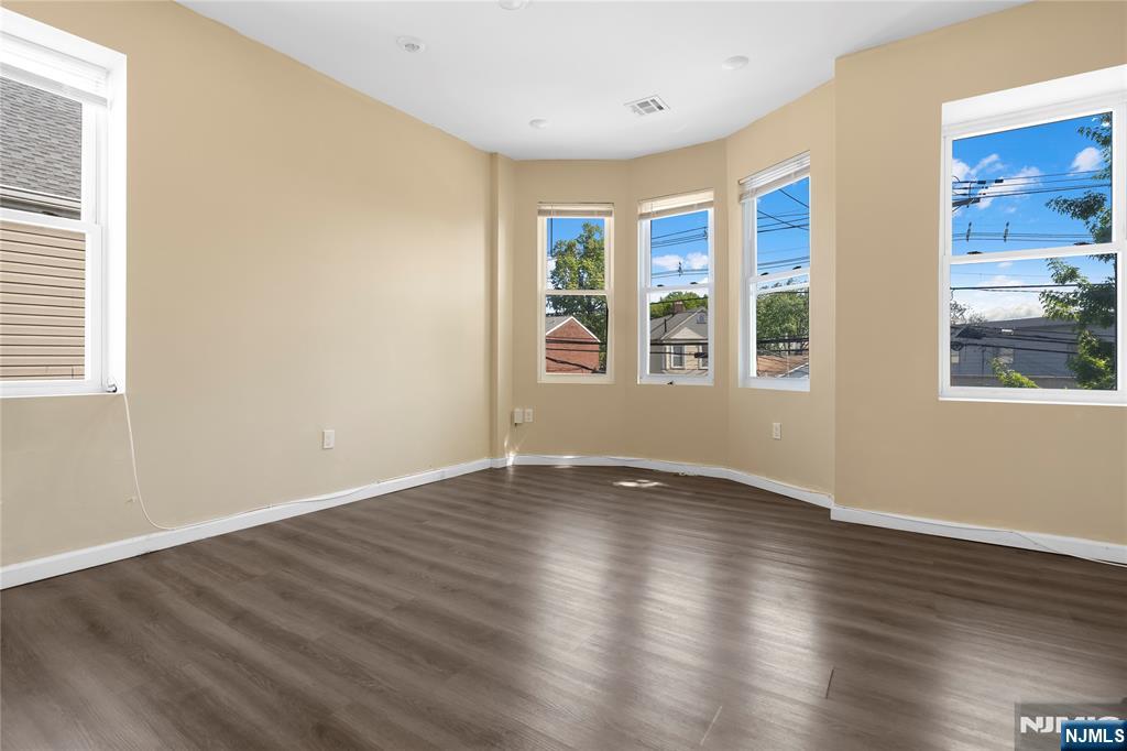 183 Bergen Turnpike Ridgefield Park, NJ 07660 - Photo 15 of 18 an empty room with wooden floor and windows