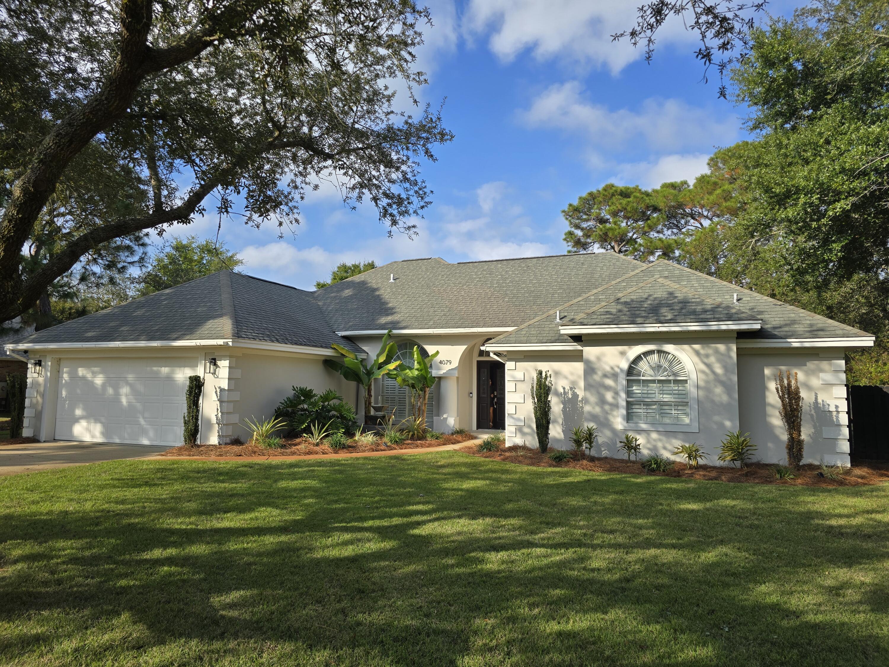 a front view of house with yard and green space