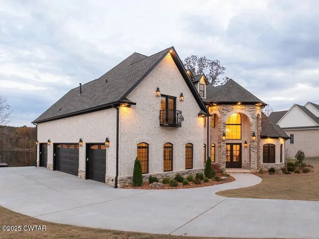 a swimming pool with outdoor seating and yard in the back