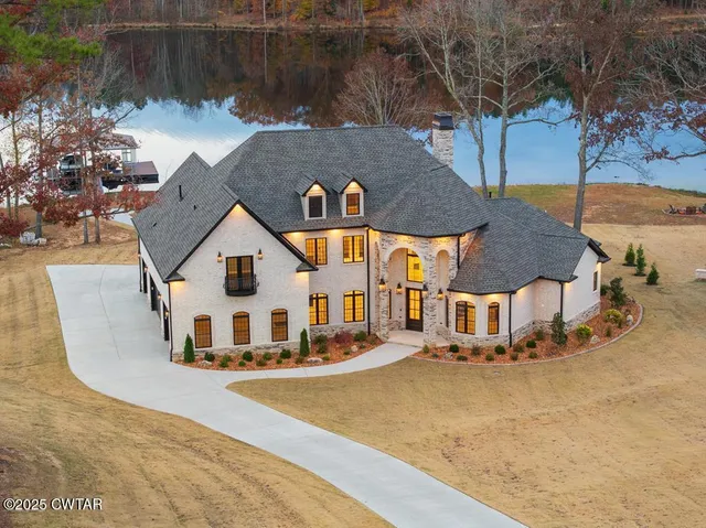 an aerial view of a house with swimming pool and sitting area