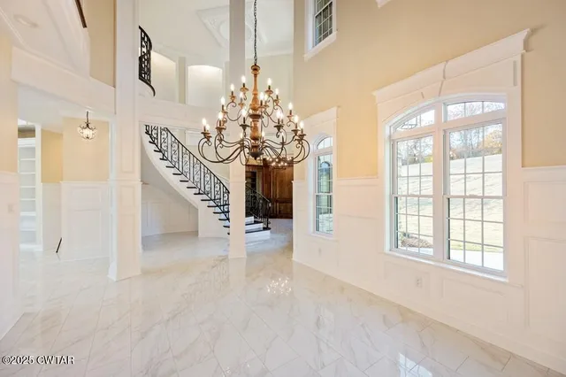 a large kitchen with stainless steel appliances kitchen island granite countertop a refrigerator and a sink