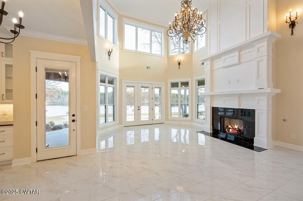 425 Shoreview Lane Huntingdon, TN 38344 - Photo 26 of 65 a view of a livingroom with a fireplace large windows and a ceiling fan