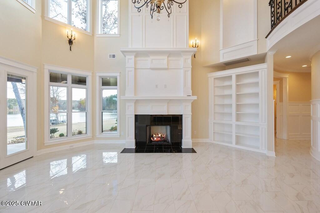 425 Shoreview Lane Huntingdon, TN 38344 - Photo 27 of 65 a living room with a fireplace and a large window