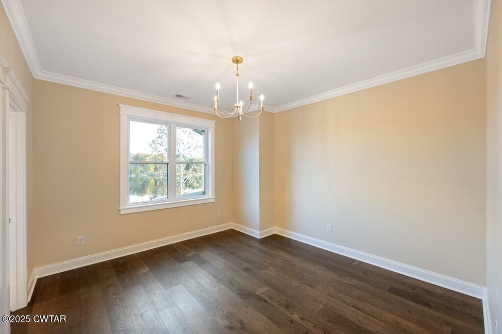 425 Shoreview Lane Huntingdon, TN 38344 - Photo 60 of 65 an empty room with wooden floor chandelier and windows
