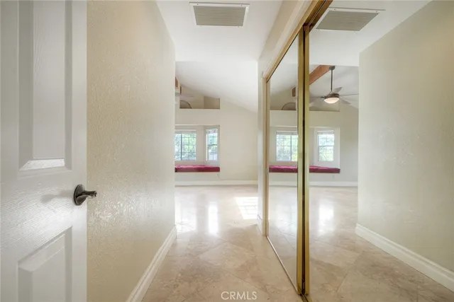 a spacious bathroom with a granite countertop double vanity and a mirror