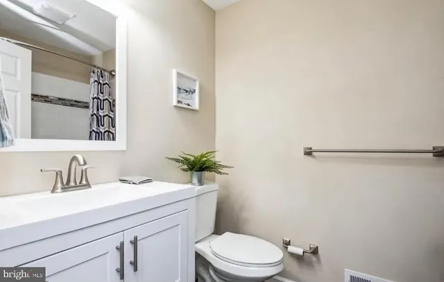 a bathroom with a sink a toilet a shower and a mirror