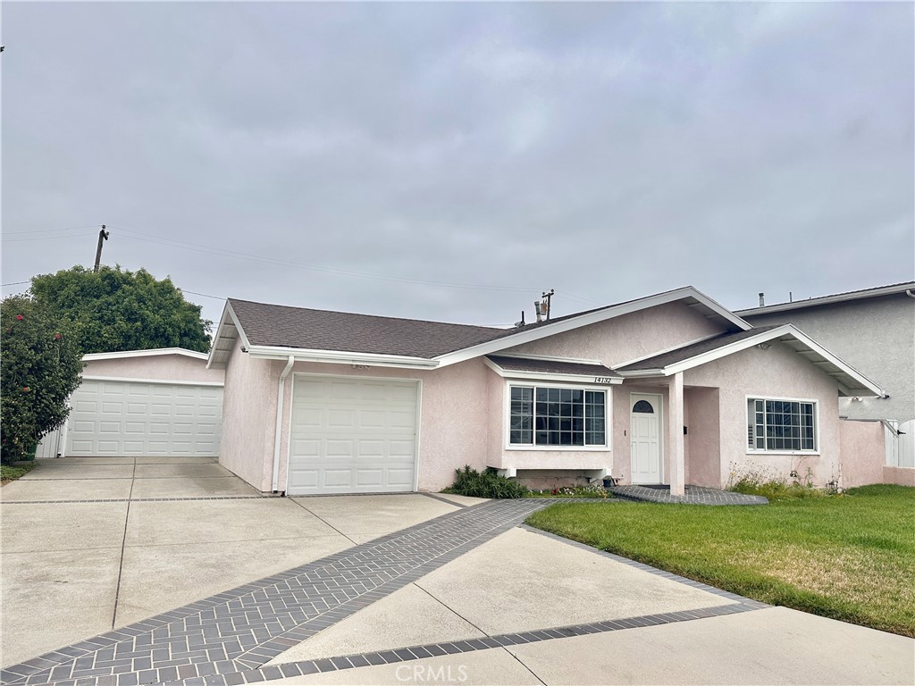 14132 Roxanne Drive Westminster, CA 92683 - Photo 12 of 36 a front view of a house with a yard and garage