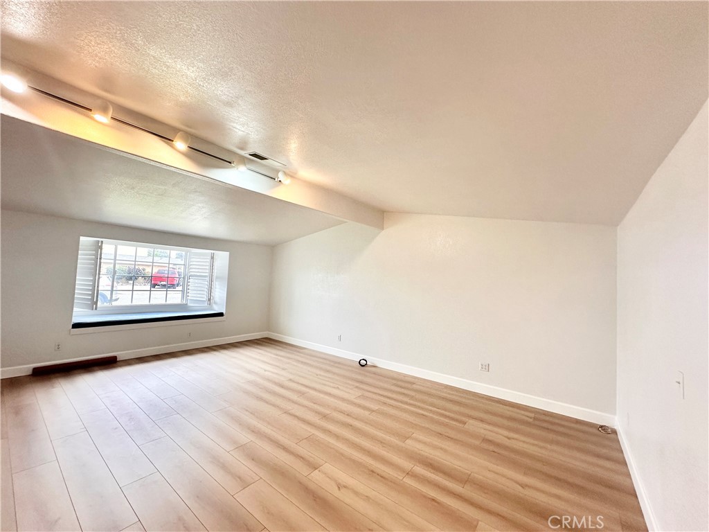 14132 Roxanne Drive Westminster, CA 92683 - Photo 14 of 36 an empty room with wooden floor and windows