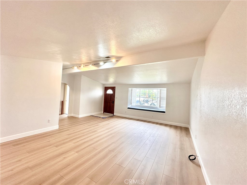14132 Roxanne Drive Westminster, CA 92683 - Photo 16 of 36 an empty room with wooden floor and windows