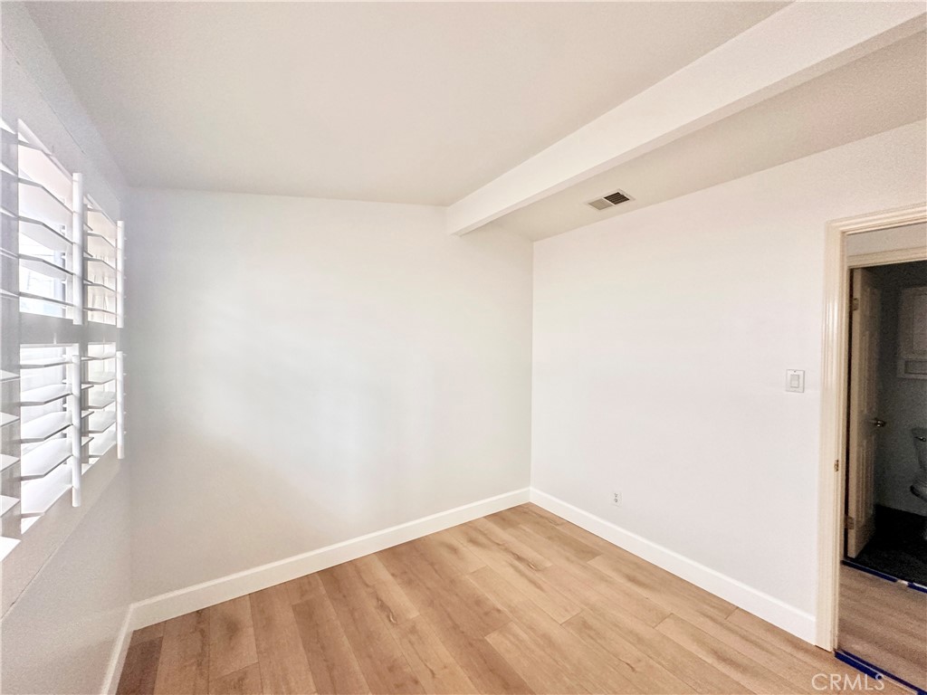 14132 Roxanne Drive Westminster, CA 92683 - Photo 21 of 36 a view of an empty room with wooden floor and a window