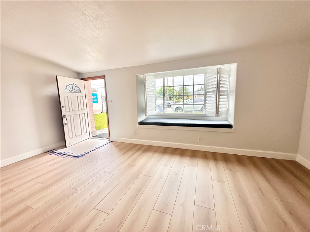14132 Roxanne Drive Westminster, CA 92683 - Photo 33 of 36 a view of an empty room with wooden floor and a window