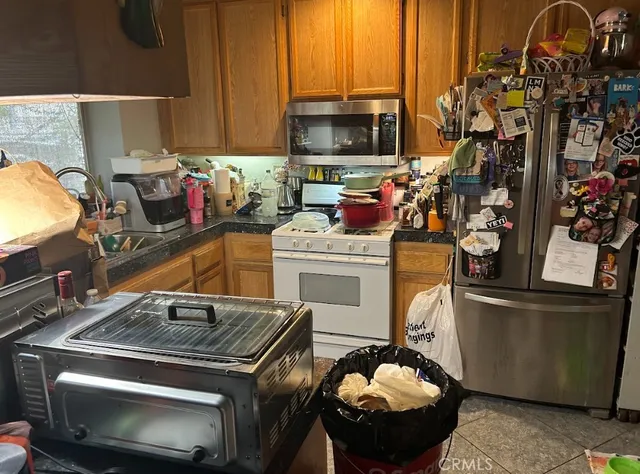 a kitchen with granite countertop a stove and a sink