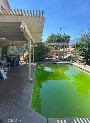 a view of a swimming pool with a patio