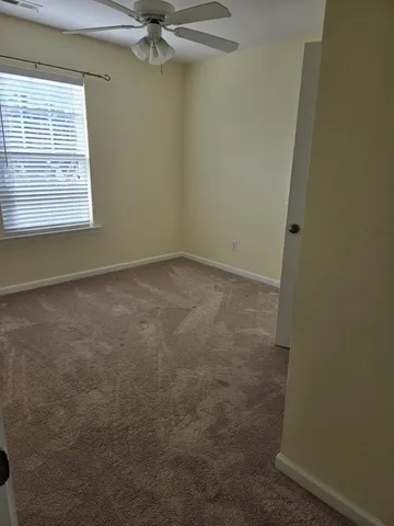 a view of a small space with wooden floor and a window
