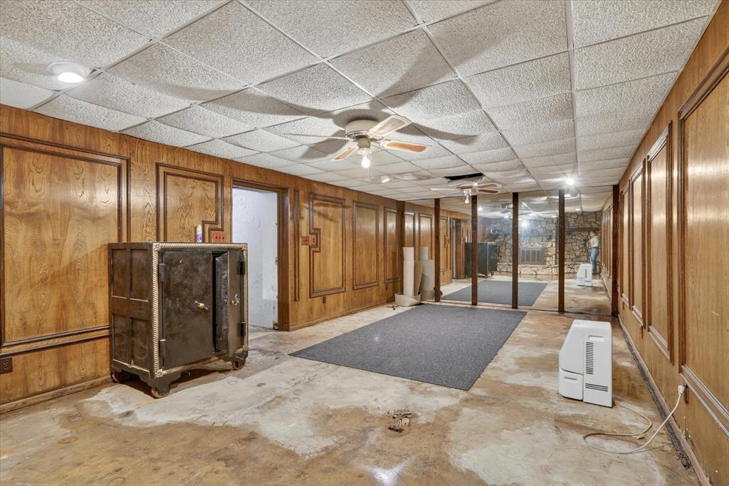 1092 West Highway 199 Springtown, TX 76082 - Photo 19 of 29 Basement space with wood paneling, drop ceiling, and recessed lighting