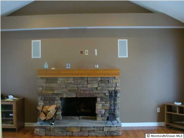 75 Lloyd Road Morganville, NJ 07751 - Photo 2 of 3 a living room with furniture and a fireplace