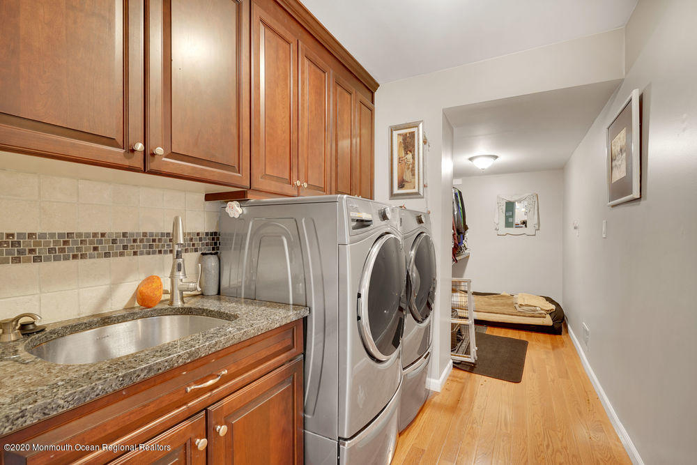 16 Woods Road West Long Branch, NJ 07764 - Photo 13 of 38 a kitchen with stainless steel appliances granite countertop a sink a stove and washer
