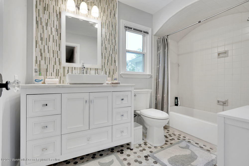 16 Woods Road West Long Branch, NJ 07764 - Photo 17 of 38 a bathroom with a sink toilet and window