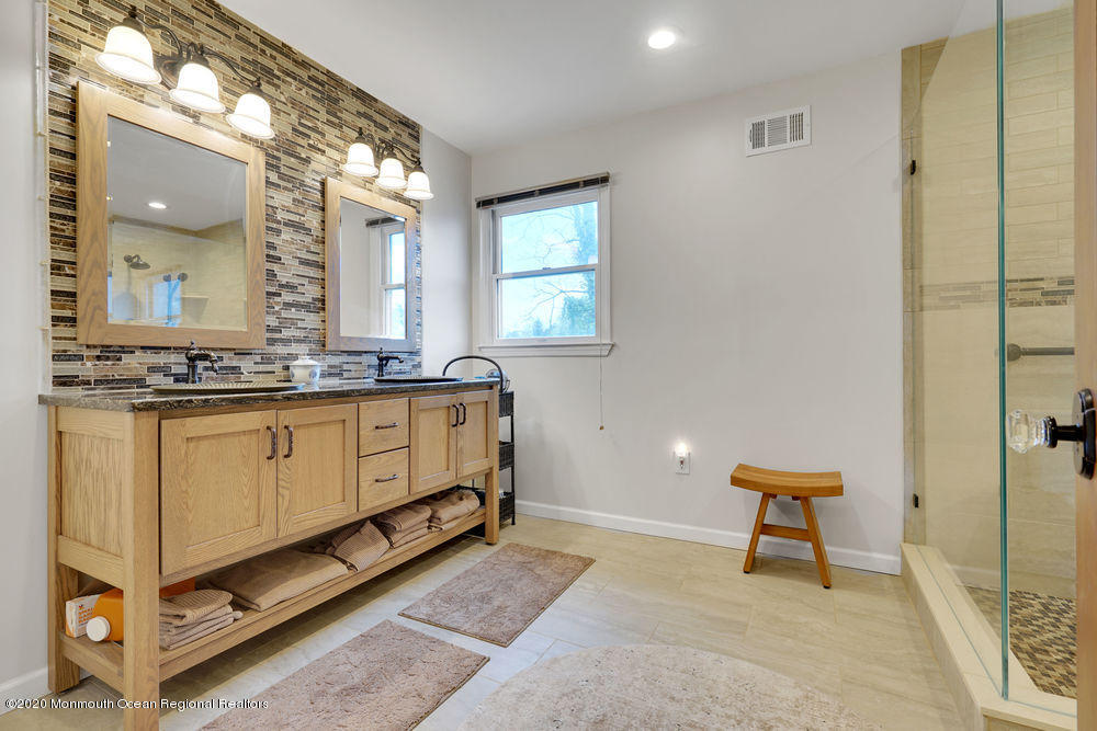 16 Woods Road West Long Branch, NJ 07764 - Photo 23 of 38 a bathroom with a sink a mirror and a toilet