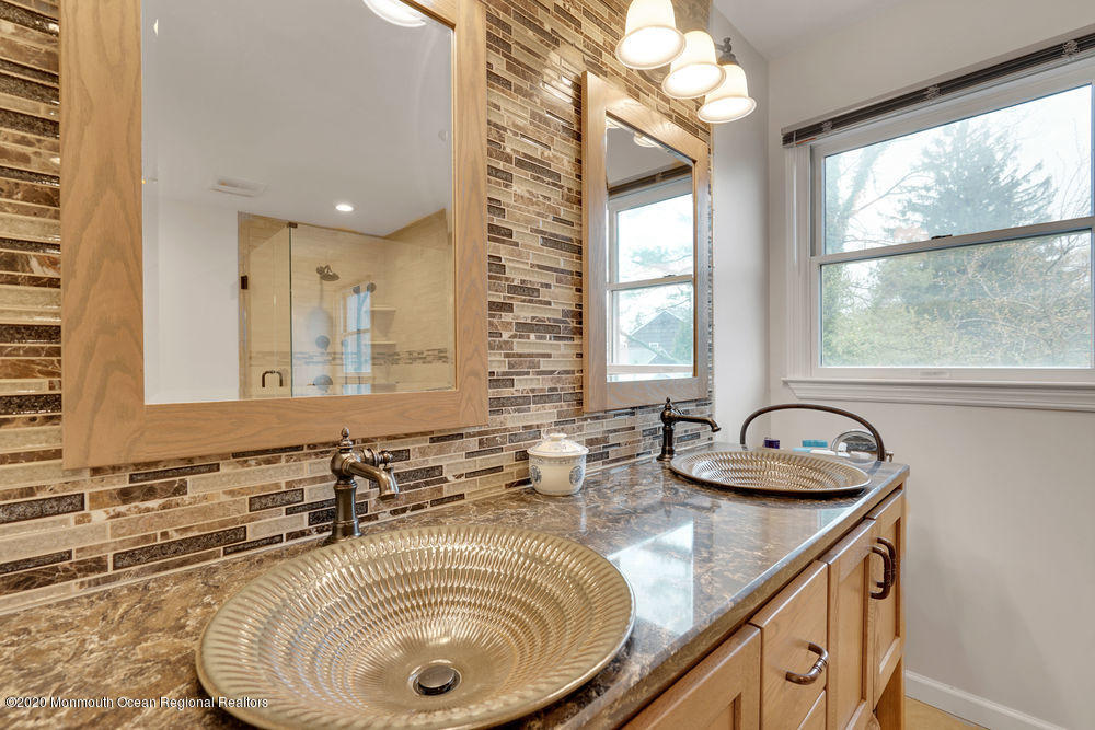 16 Woods Road West Long Branch, NJ 07764 - Photo 24 of 38 a bathroom with a granite countertop sink and a large mirror