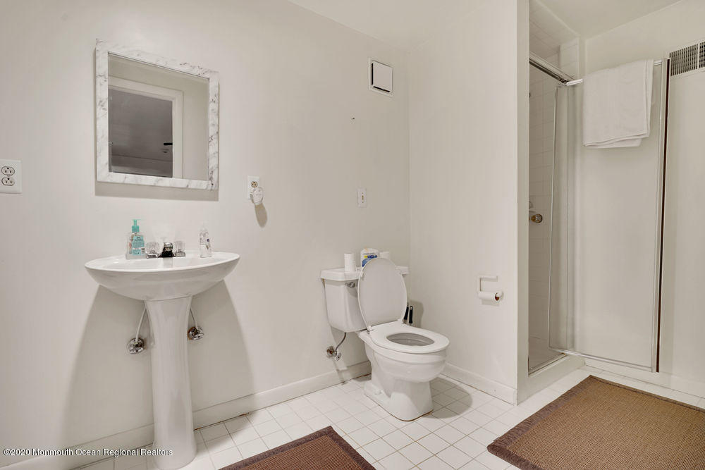 16 Woods Road West Long Branch, NJ 07764 - Photo 31 of 38 a bathroom with a toilet sink and mirror