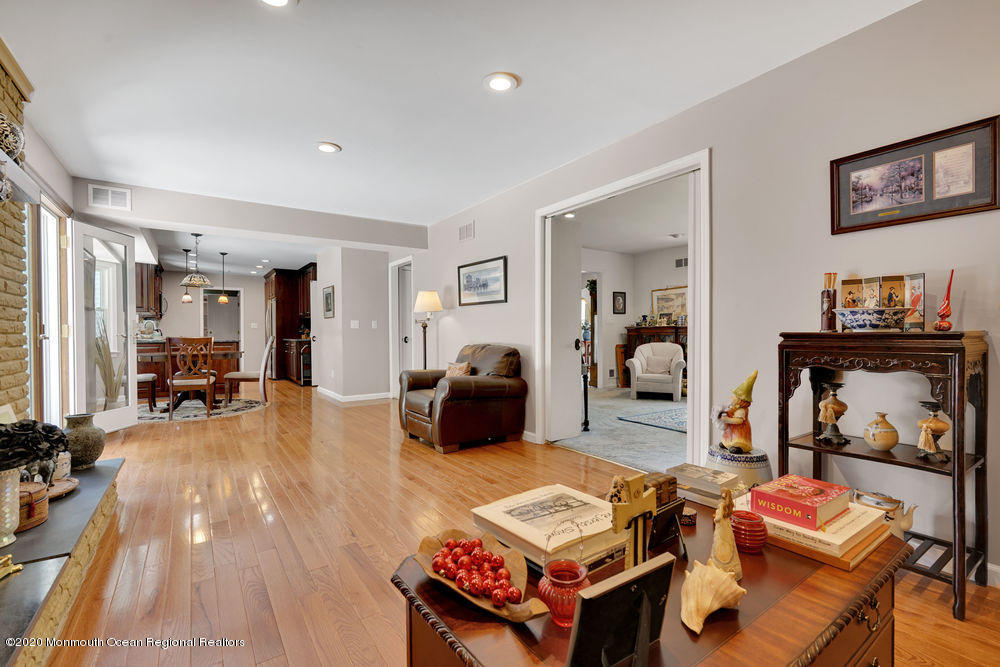 16 Woods Road West Long Branch, NJ 07764 - Photo 6 of 38 a living room with furniture a flat screen tv and a refrigerator
