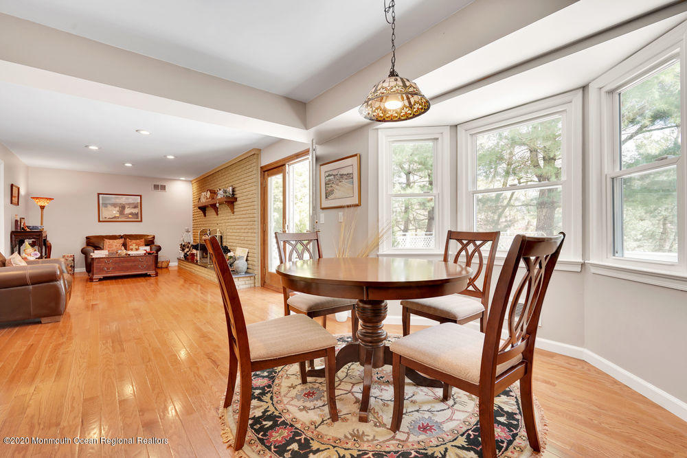 16 Woods Road West Long Branch, NJ 07764 - Photo 8 of 38 a dining room with furniture a chandelier and wooden floor