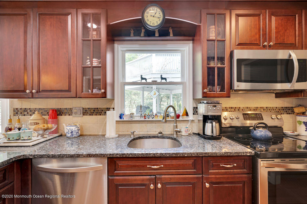 16 Woods Road West Long Branch, NJ 07764 - Photo 9 of 38 a kitchen with granite countertop a sink stainless steel appliances and cabinets