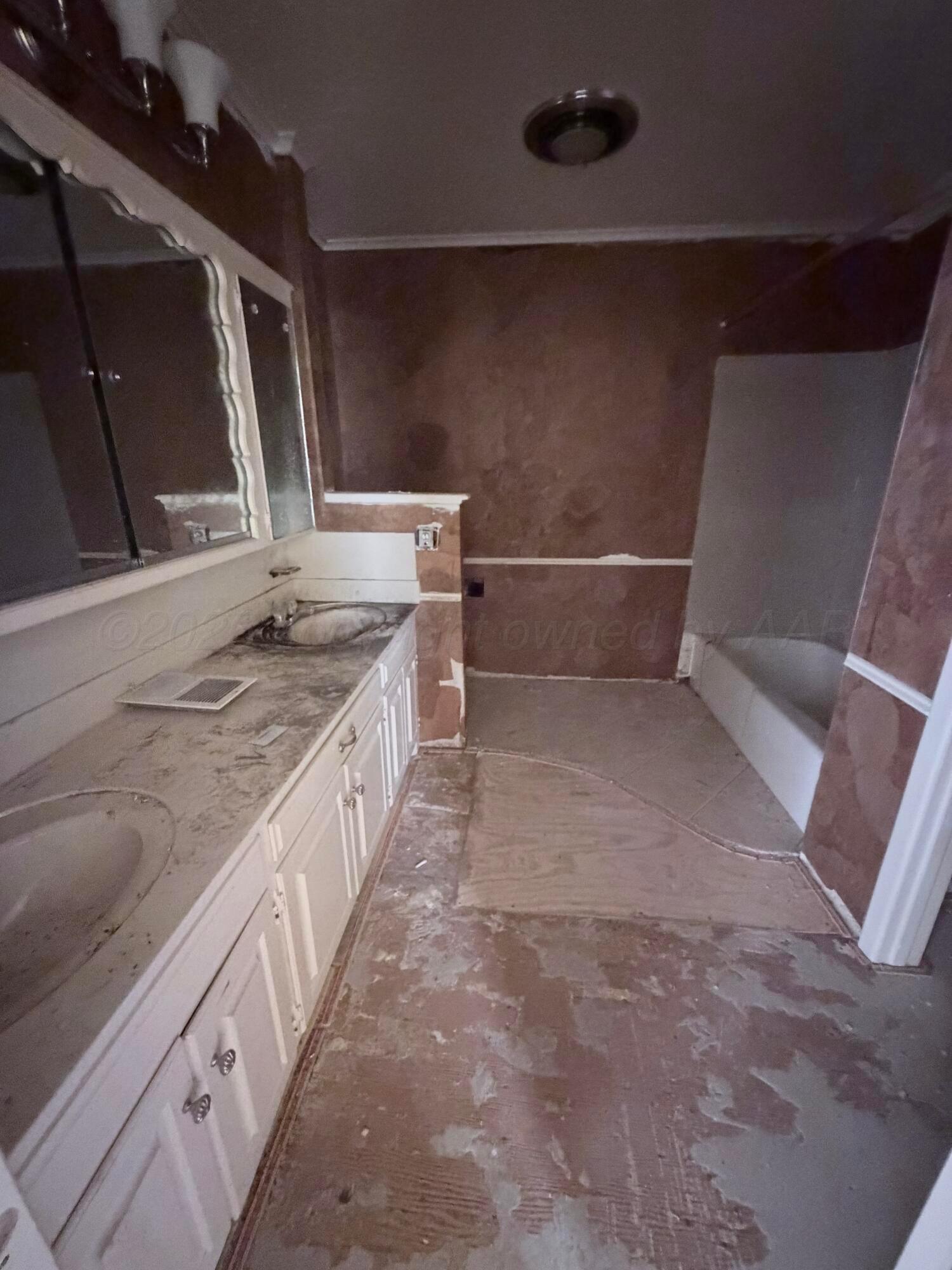 3113 Southwest 28th Avenue Amarillo, TX 79109 - Photo 9 of 10 a bathroom with a granite countertop sink and a mirror