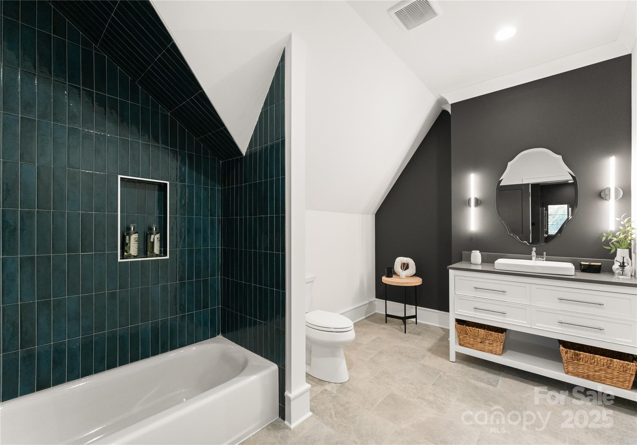 4142 Pineview Road Charlotte, NC 28211 - Photo 25 of 38 a bathroom with a double vanity sink a toilet a mirror and bathtub