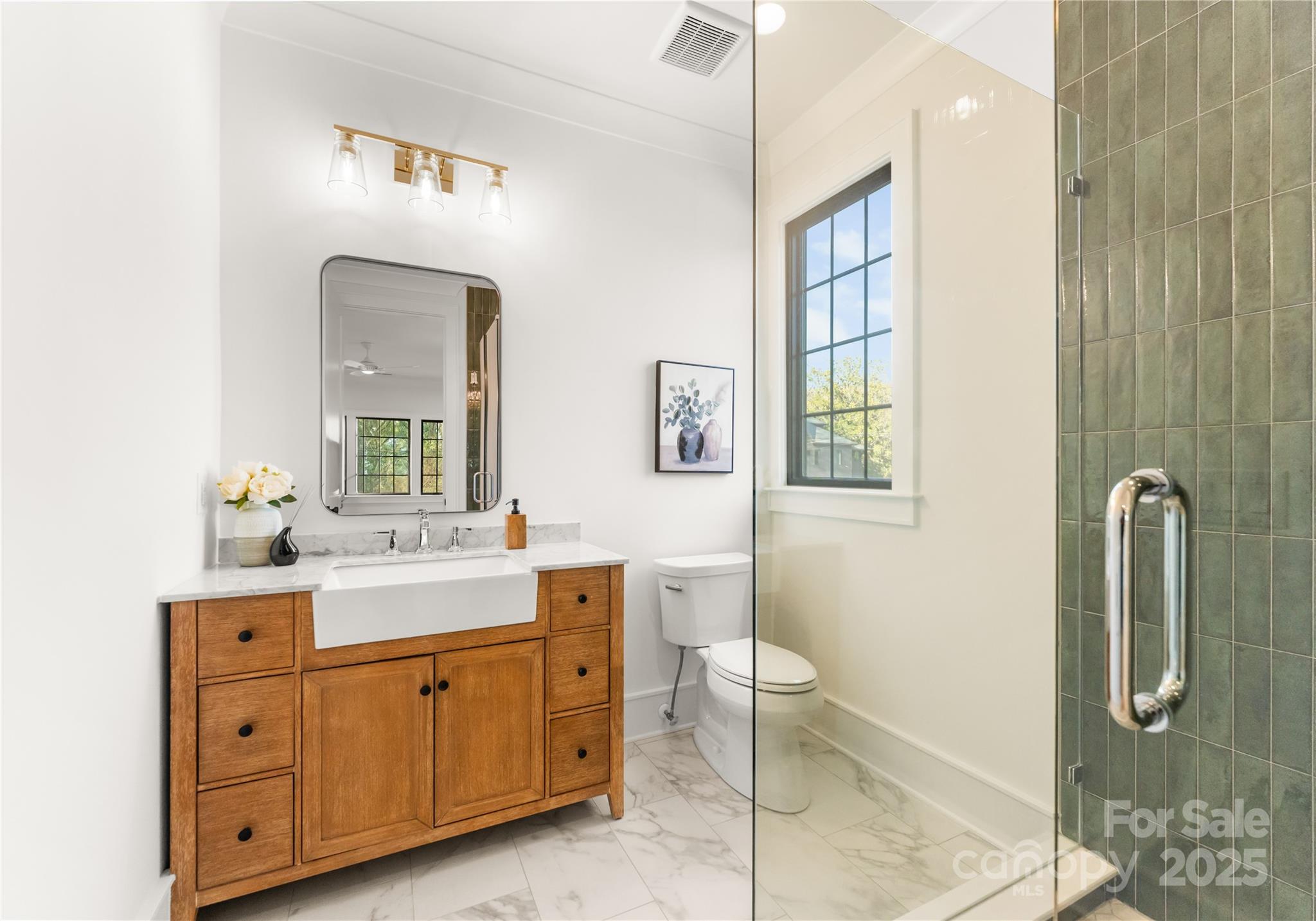 4142 Pineview Road Charlotte, NC 28211 - Photo 26 of 38 a spacious bathroom with a double vanity sink a mirror and a shower
