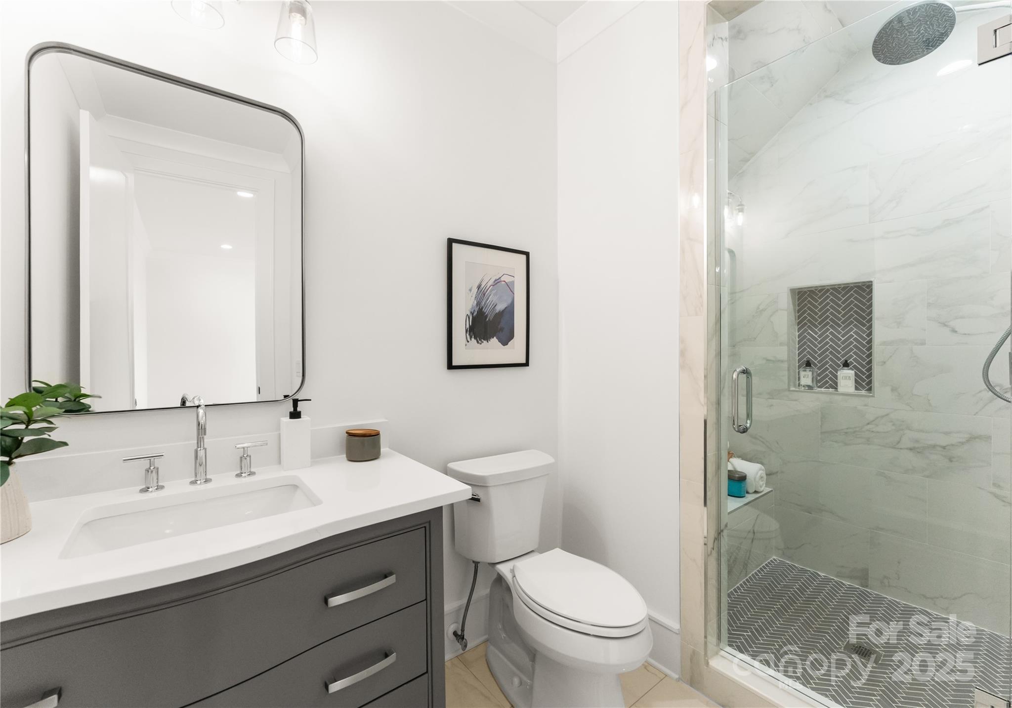 4142 Pineview Road Charlotte, NC 28211 - Photo 29 of 38 a bathroom with a sink a toilet and shower