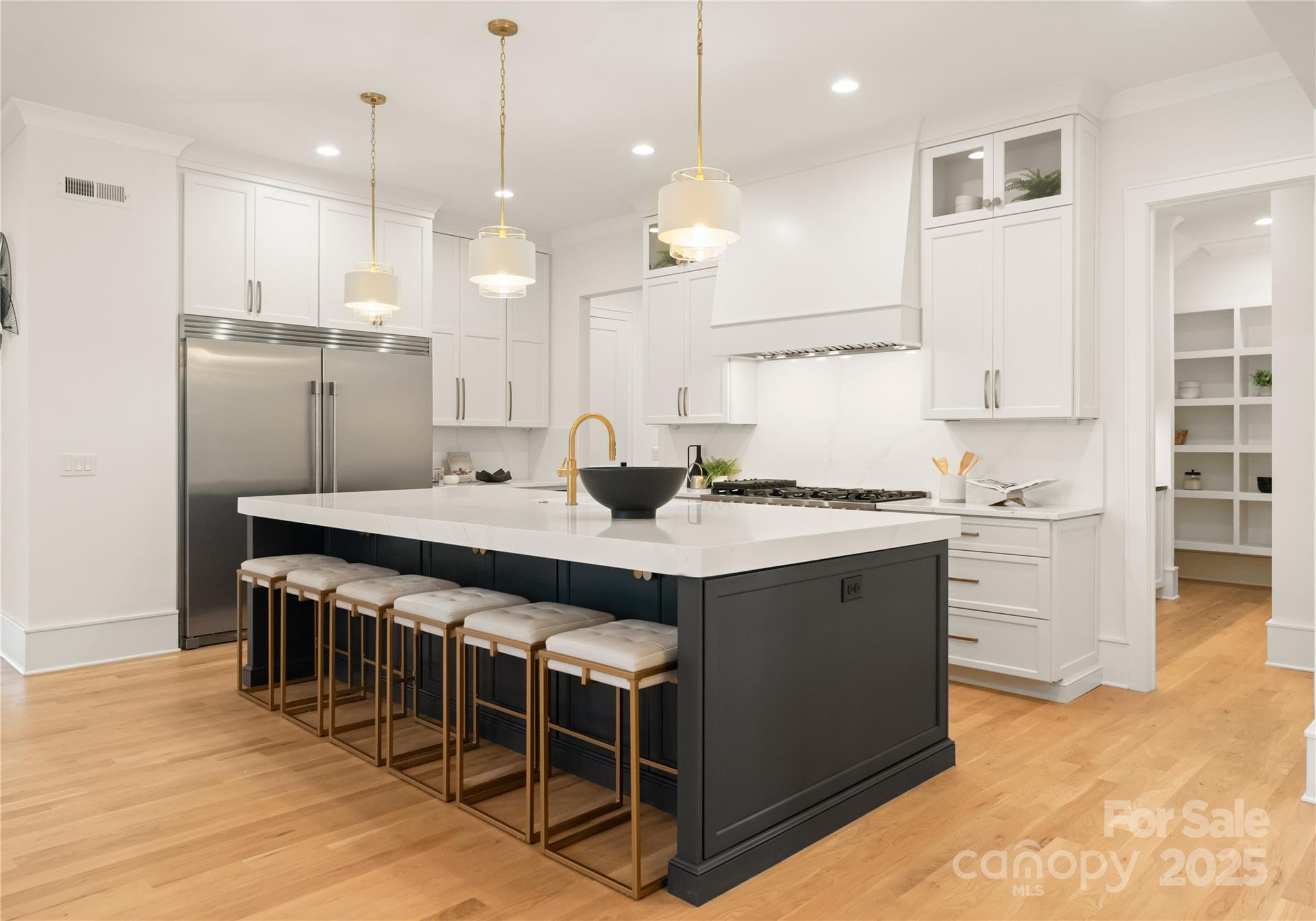 4142 Pineview Road Charlotte, NC 28211 - Photo 6 of 38 a large kitchen with kitchen island a sink a stove a center island a dining table and chairs