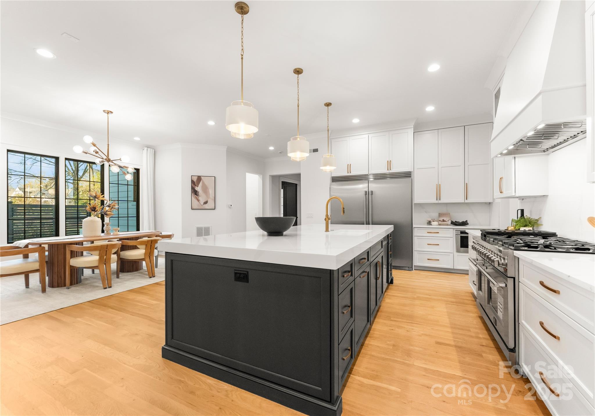 4142 Pineview Road Charlotte, NC 28211 - Photo 7 of 38 a kitchen with stainless steel appliances granite countertop a sink a stove and a wooden floor